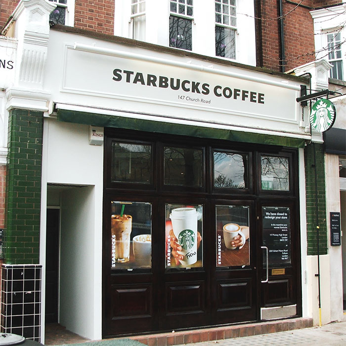 shop sign fitted above Starbucks storefront